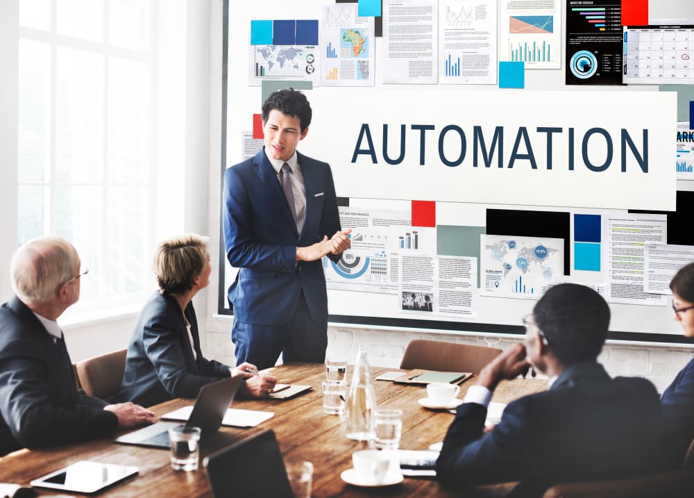 Professional presenting automation strategy on a whiteboard