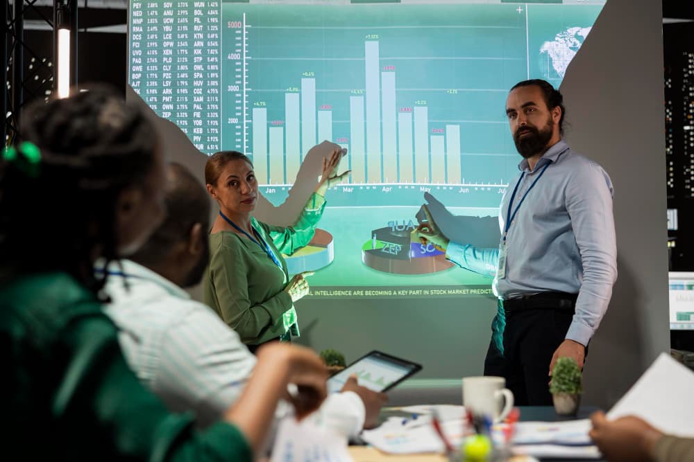 Sales team reviewing CPQ dashboards on a large display